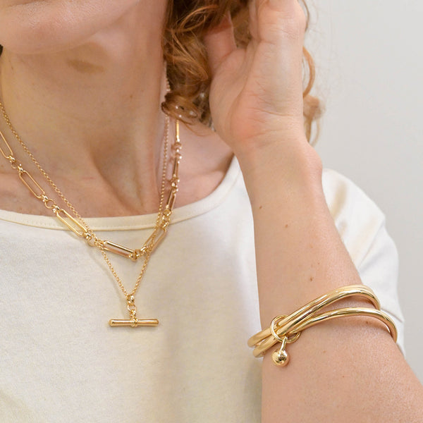 Peace of Mind Golden bangle stack with ball charm