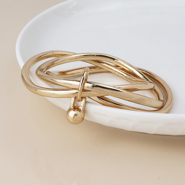 Peace of Mind Golden bangle stack with ball charm