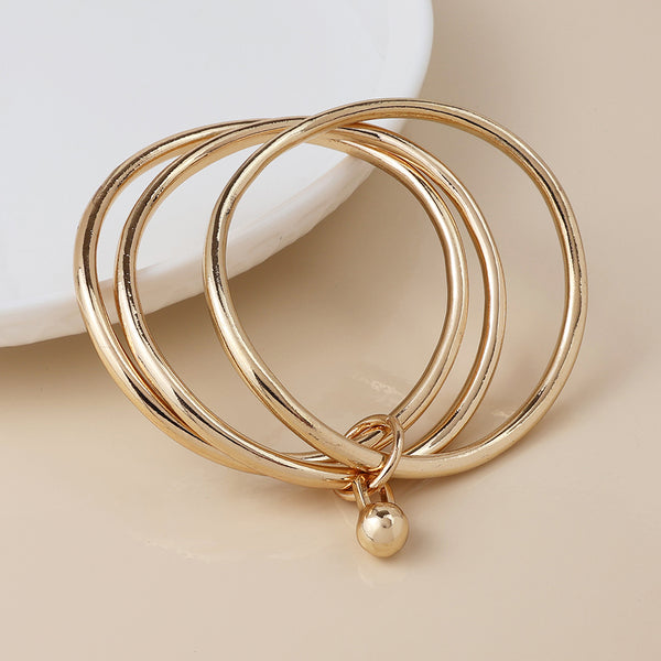 Peace of Mind Golden bangle stack with ball charm
